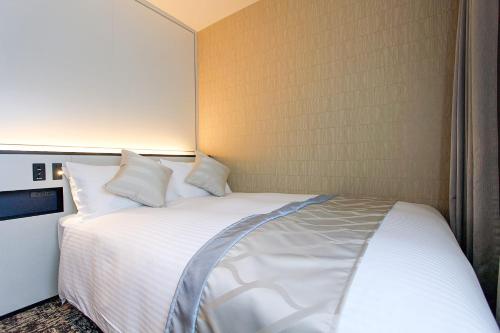 a bedroom with a white bed in a room at Best Western Plus Nagoya Sakae in Nagoya