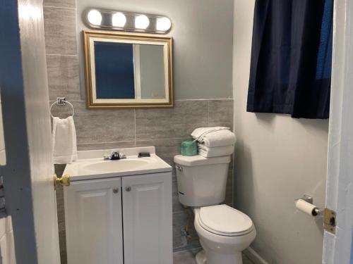 a bathroom with a toilet and a sink and a mirror at Superlodge in Dover