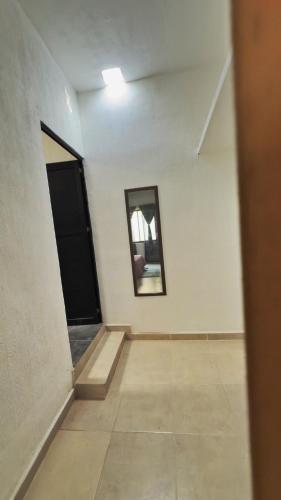 an empty room with a hallway with a door and a mirror at Villa Cerro Escondido in Chiapa de Corzo