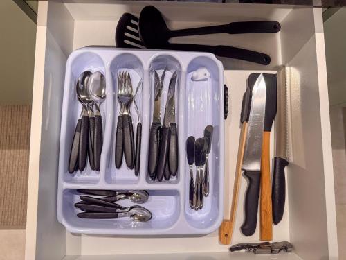 a plastic container filled with utensils in a drawer at Apto perto da FIP, Stop Shop in Brusque