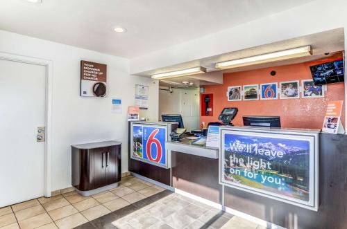 a mcdonalds restaurant with a counter with a sign at Motel 6 Fort Collins, CO in Fort Collins