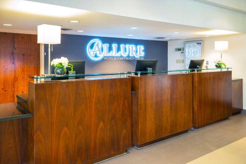 a lobby with a waiting area with aurance sign on the wall at Allure Hotel & Conference Centre, Ascend Hotel Collection in Barrie