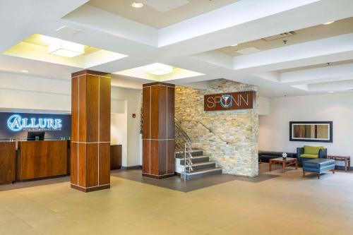 a lobby with a sign on a stone wall at Allure Hotel & Conference Centre, Ascend Hotel Collection in Barrie