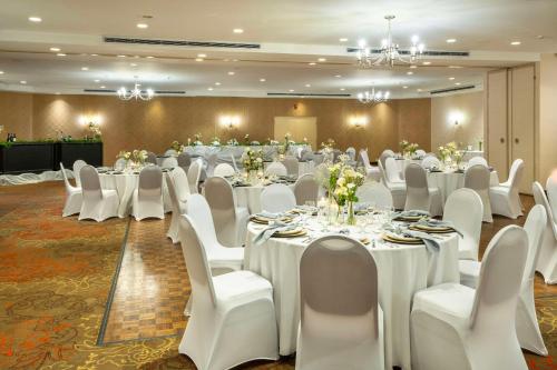 a banquet hall with white tables and white chairs at Allure Hotel & Conference Centre, Ascend Hotel Collection in Barrie