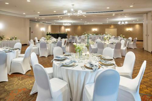 a banquet hall with white tables and white chairs at Allure Hotel & Conference Centre, Ascend Hotel Collection in Barrie