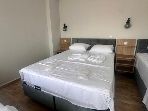 a bedroom with a large bed with white sheets and pillows at Avka Palace in Edirne