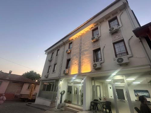 a white building with a table in front of it at Avka Palace in Edirne