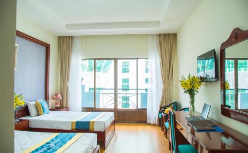 a hotel room with two beds and a window at Ninh Kieu Riverside Hotel in Can Tho