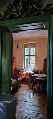 a living room with a table and a window at Rózsilak in Balatonfüred