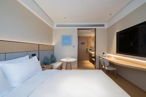 Postel nebo postele na pokoji v ubytování JI Hotel Beijing Xizhimen Jiaotong University