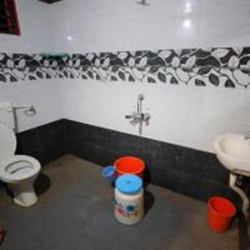 a bathroom with a toilet and a sink at Dandeli Hidden Valley by StayApart in Ganeshgudi