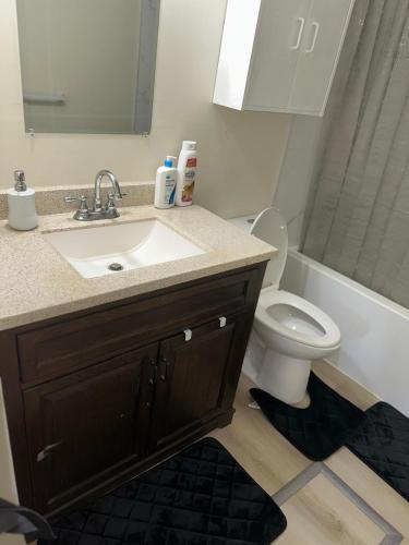 a bathroom with a sink and a toilet at Joyful Home Regina in Regina