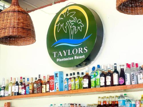 a sign for taylorons plantationlords hanging on a store shelf at Taylors Plantacion Resort- Bungalow Villa in Catarman