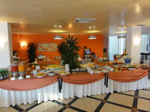 a long table with food on it in a room at Cefalù Sea Palace in Cefalù