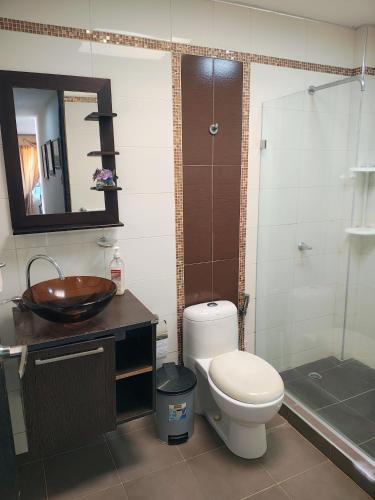 a bathroom with a toilet and a sink and a shower at Casa Fenix in Dibulla