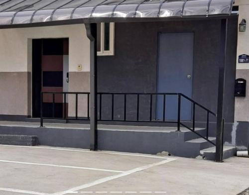 a building with a balcony and a door and a parking lot at Yangyang Haewasol House in Yangyang