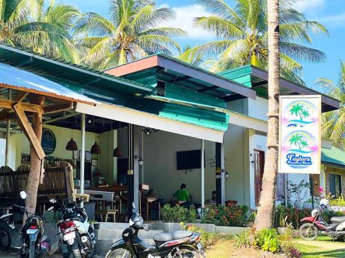 a group of motorcycles parked in front of a restaurant at Taylors Plantacion Resort- Grande Second Floor in Catarman