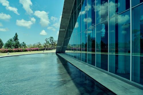 an external view of a building with a pool of water at RIMBA by AYANA Bali in Jimbaran