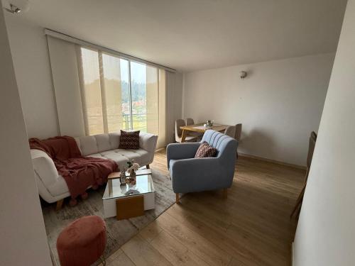 a living room with a couch and a table at Confort 203 Apartamento Duitama in Duitama