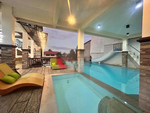 a large swimming pool in a building with a swimming pool at Sv hotspring resort in Calamba