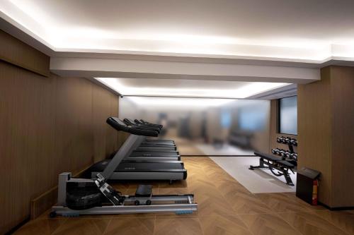 a room with a gym with a treadmill at Guangzhou Huayu Wanfu Hotel-Free Shuttle Bus to Canton Fair Complex During Canton Fair Period in Guangzhou