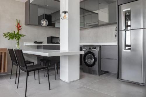 a kitchen with a counter and a washing machine at Beach Loft next to the Sheraton Leblon in Rio de Janeiro