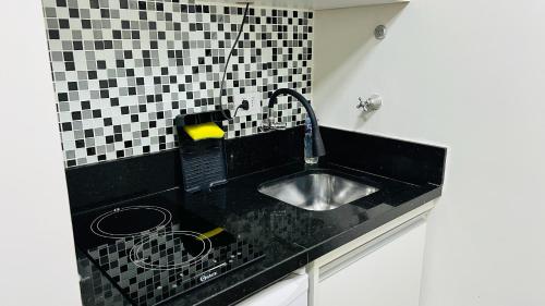 Kuchyň nebo kuchyňský kout v ubytování Flat Aconchegante - Drummond