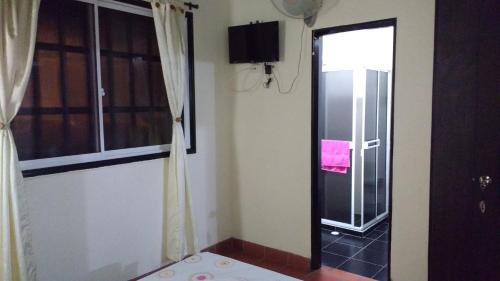 a room with a door leading to a balcony at Habitación 4 personas Hostal centro San Gil in San Gil