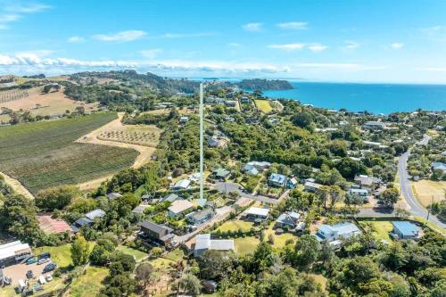 an aerial view of a suburb with the ocean at Hartlock in Onetangi in Waiheke Island