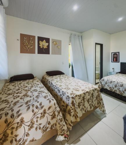 a bedroom with two beds in a room at Casasukyara in Amontada
