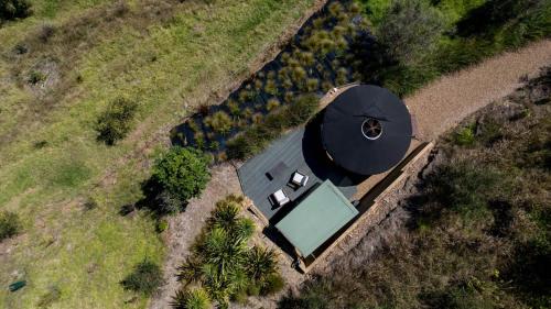 an overhead view of a house with a building at Awaawa Yurts - Papatūānuku in Waiheke Island