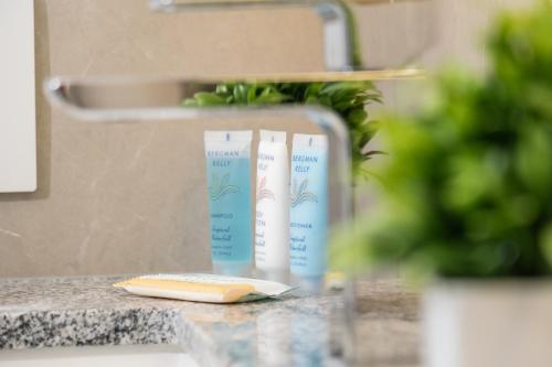 a counter with two bottles of hair products on it at Downtown Center Silverstone Tower I and II Long-Term Booking Only Your second home in Vancouver in Vancouver