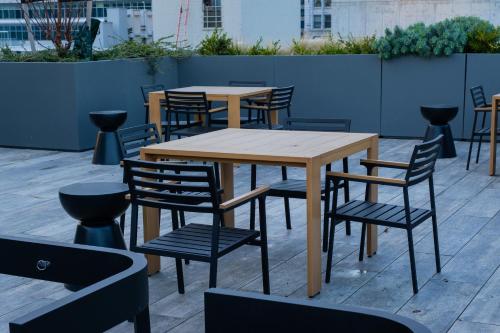 a wooden table and chairs on a patio at Downtown Center Silverstone Tower I and II Long-Term Booking Only Your second home in Vancouver in Vancouver