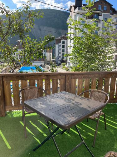a table and two chairs on a balcony at Family Plai in Yaremche
