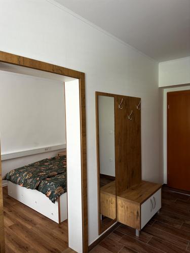 a bedroom with a mirror next to a bed at Gostilna Menina in Gornji Grad