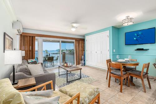 a living room with a couch and a table at Ocean Echoes: Kona’s Oceanfront Family Oasis in Kailua-Kona