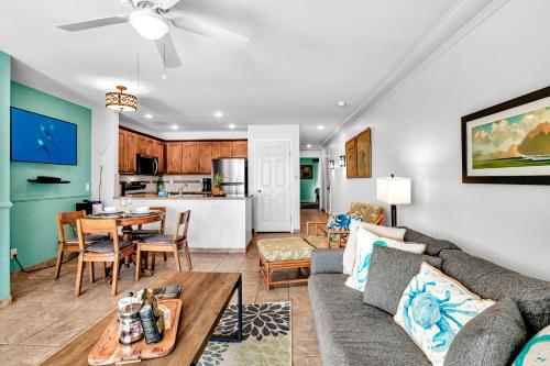 a living room with a couch and a table at Ocean Echoes: Kona’s Oceanfront Family Oasis in Kailua-Kona