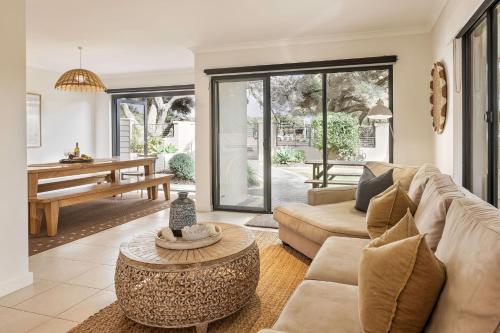 a living room with a couch and a table at Sunset and Surfside in Yallingup