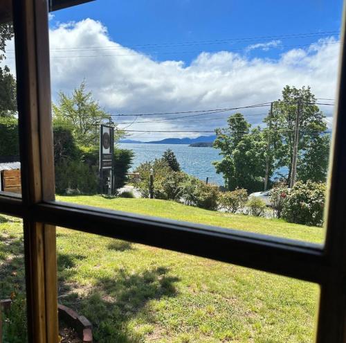 a view of the water from a window at Hermosas Cabañas con vista al Nahuel Huapi in San Carlos de Bariloche