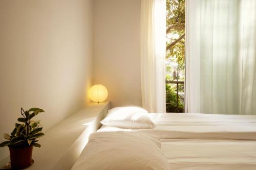 a bedroom with two beds and a window at Pyoseon Mansion in Seogwipo