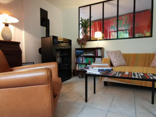 a living room with a couch and a coffee table at Le moulin de La Retardière in Orvault