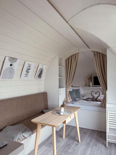 a living room with a table and a bed at IGLU Camp Tangermünde in Tangermünde