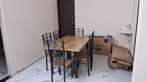 a table and chairs in a room with a box at ELCI Residence PG luxury womens hostel Tambaram in Chennai