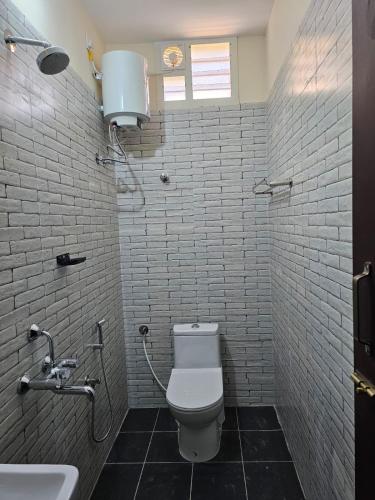 a bathroom with a toilet and a sink at ELCI Residence PG luxury womens hostel Tambaram in Chennai