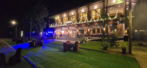 a night view of a building with tables and lights at Riviera Resort in Batticaloa
