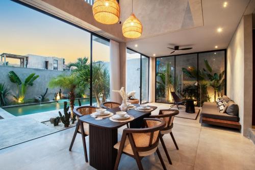a dining room with a table and chairs in a house at Balenji Villa by BaliSuperHost in Munggu