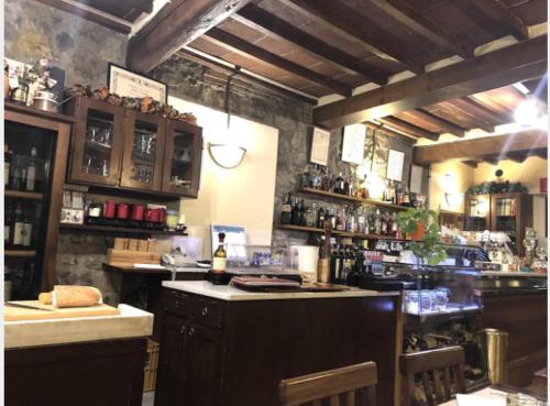 a bar in a restaurant with a counter and a bar sidx sidx at Locanda Il Gallo in Greve in Chianti