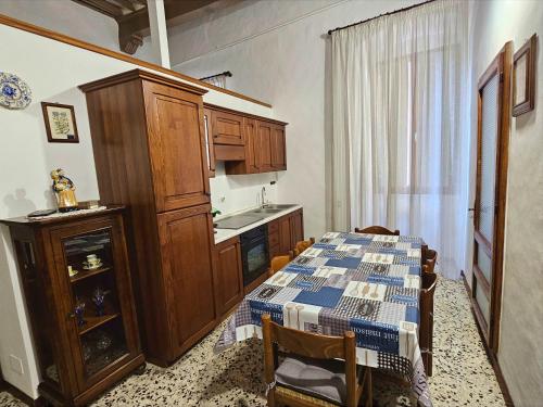a kitchen with a table with a blue and white table cloth at Dimora dei Consoli in Gubbio