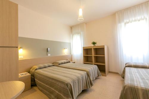 Postel nebo postele na pokoji v ubytování Hotel Colonna