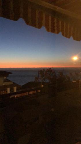 a sunset seen from a window with a train at Departamento Reñaca in Viña del Mar